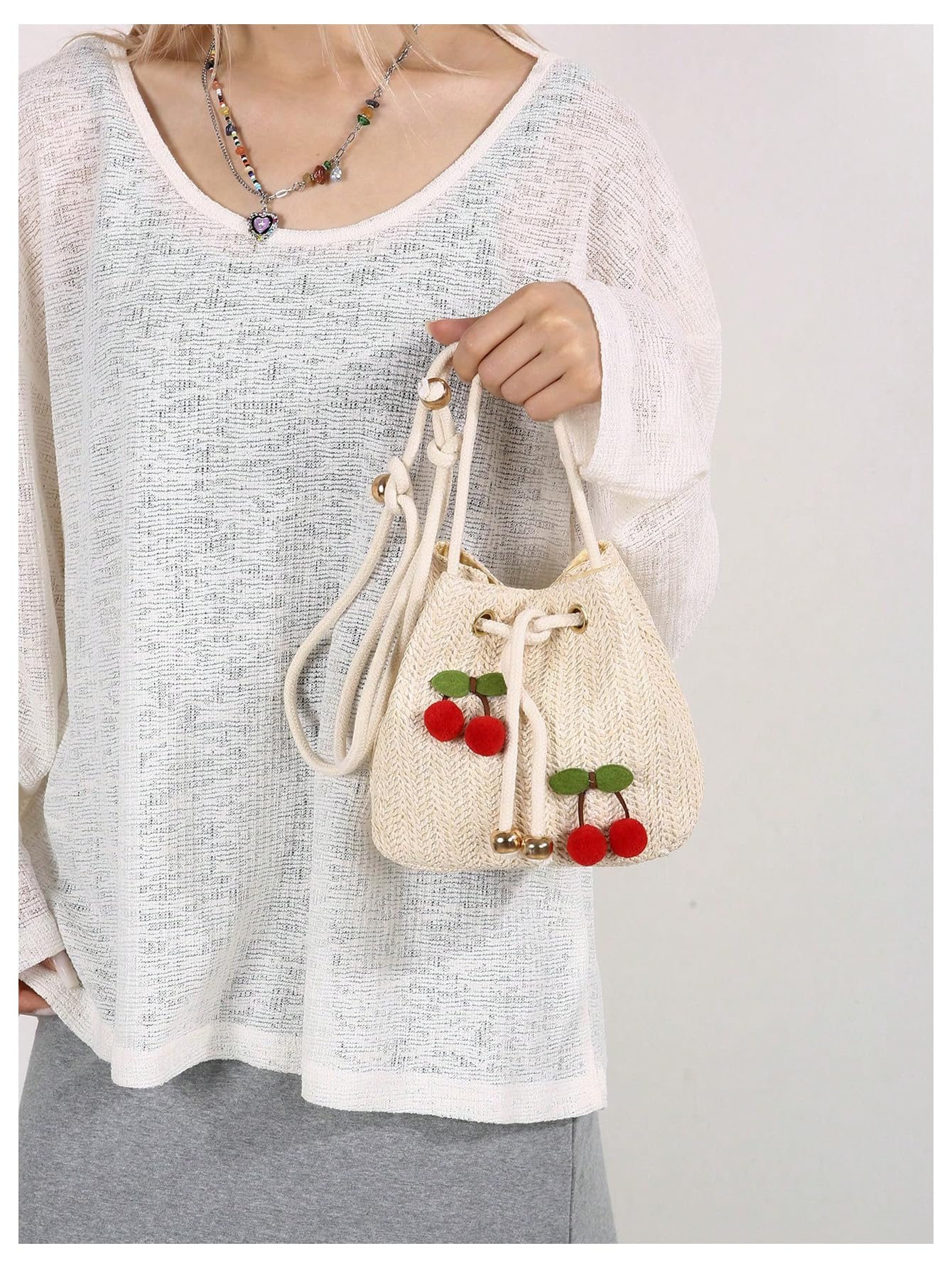 Beige woven drawstring cherry pom-pom bucket bag - Image 3